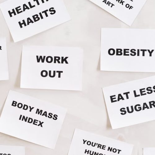 Collection of motivational quotes promoting health and wellness on paper cards.