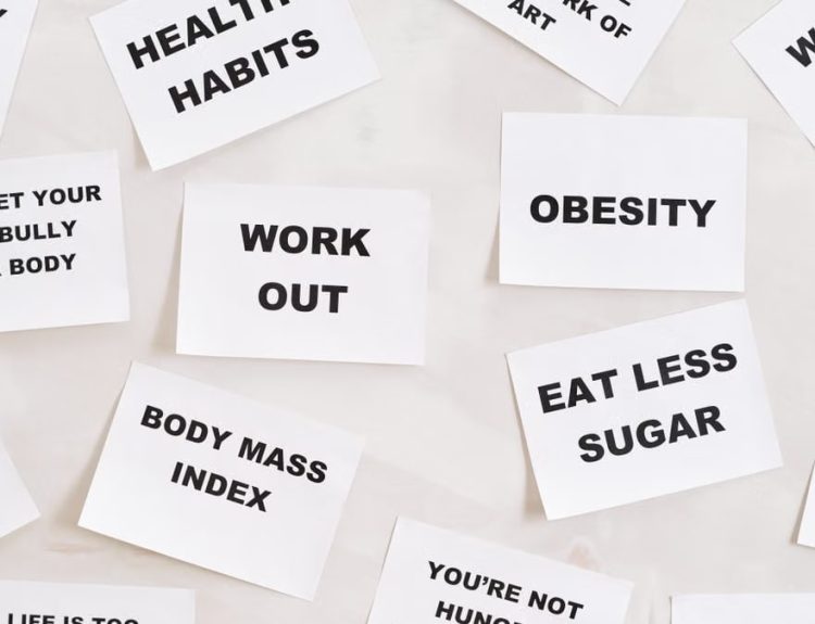 Collection of motivational quotes promoting health and wellness on paper cards.